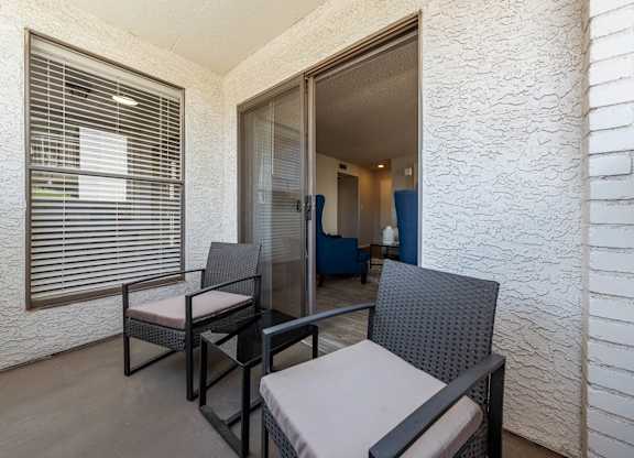 A patio with a table and chairs is shown.