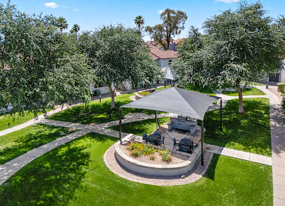 A backyard with a patio and a gazebo.