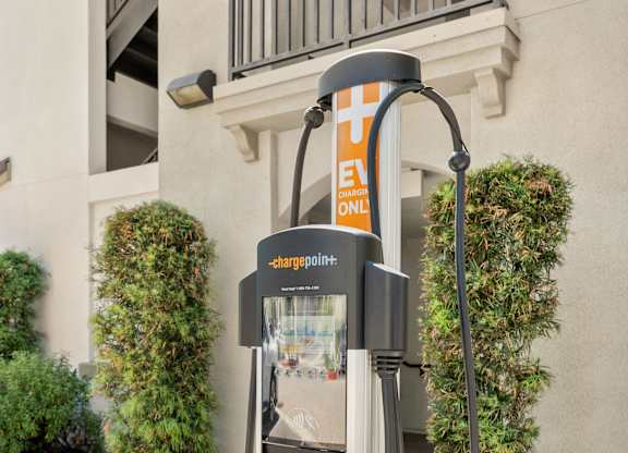 A ChargePoint electric vehicle charging station is installed on a sidewalk.