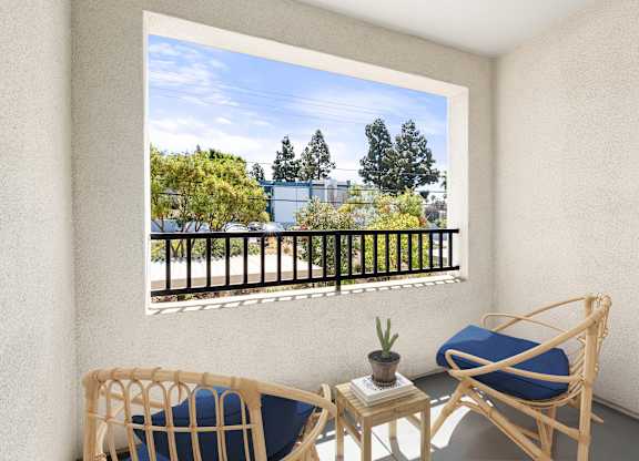 A personal patio with lounge chairs and a table.
