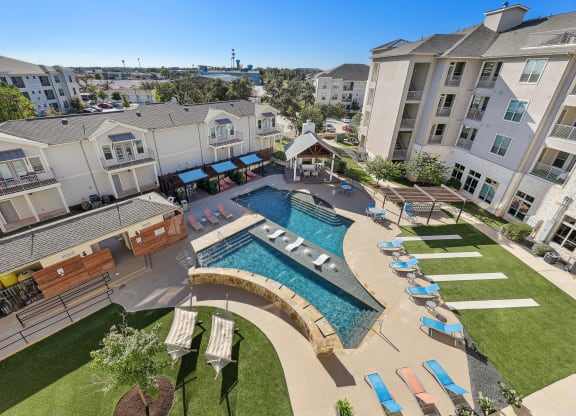 an aerial view of an apartment complex with a swimming pool