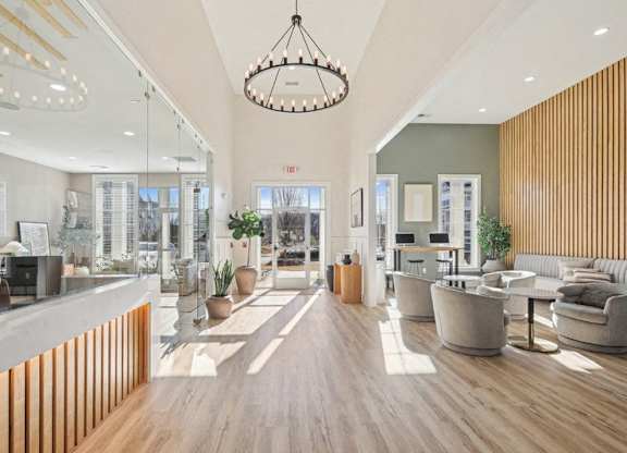 A modern office lobby with a reception desk and seating area.
