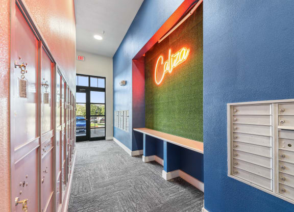 a hallway with a coca cola neon sign on the side of a building