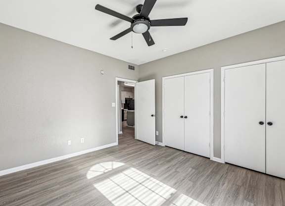 A room with a ceiling fan and three white doors at Clear Creek Meadows Apartments, Apartments, Copperas Cove, TX
