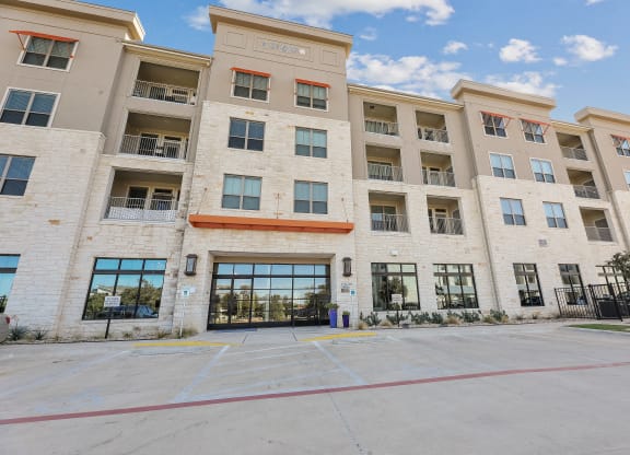 a large apartment building with a large driveway in front of it