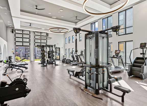 A spacious gym with a variety of equipment including treadmills, weights, and exercise machines.