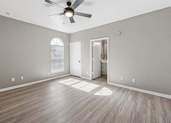 A room with a ceiling fan and wooden flooring. at Clear Creek Meadows Apartments, Copperas Cove, TX, 76522