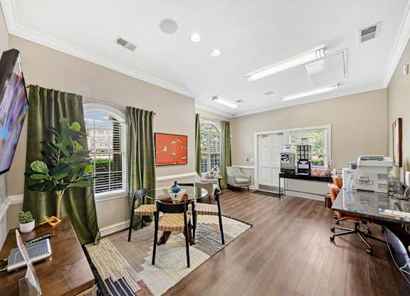 A living room with a television on the left and a dining area in the middle.