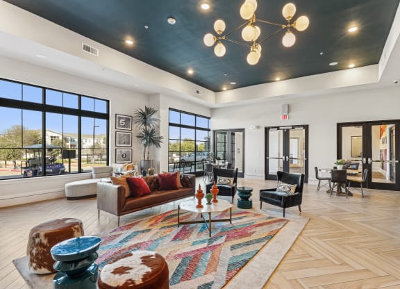 a living room with couches and chairs and a chandelier