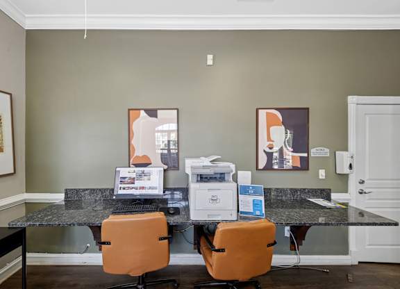 A room with a desk and two chairs.