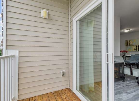 A patio door with a glass panel opens to a living room.