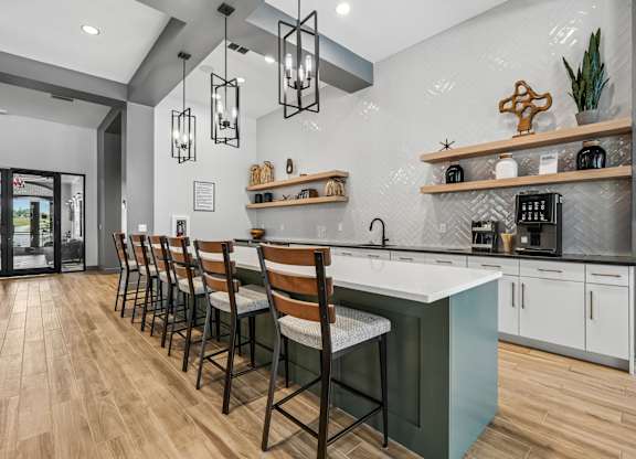 A kitchen with a long table and chairs.