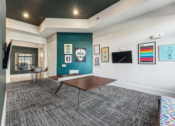 a conference room with a table and a wall with paintings