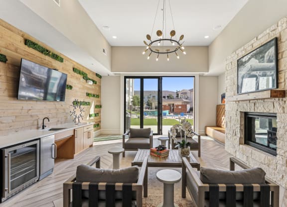 a living room with a fireplace and a table and chairs