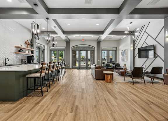 A modern kitchen with wooden floors and a long island.