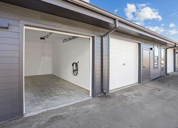 A garage with a white door and a black handle is shown.