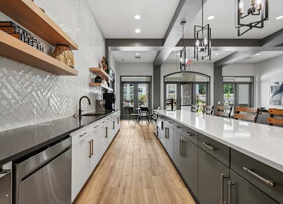 A modern kitchen with wooden floors and stainless steel appliances.
