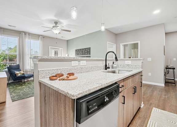 A modern kitchen with a large island and a dining area.