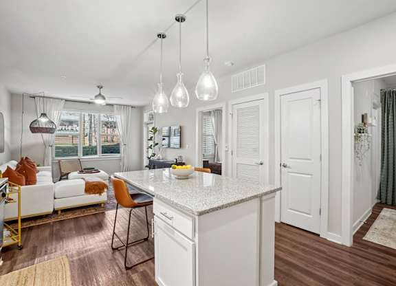 A modern kitchen with white cabinets and a central island.