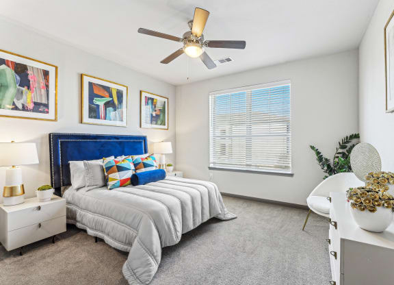 a bedroom with a bed and a ceiling fan