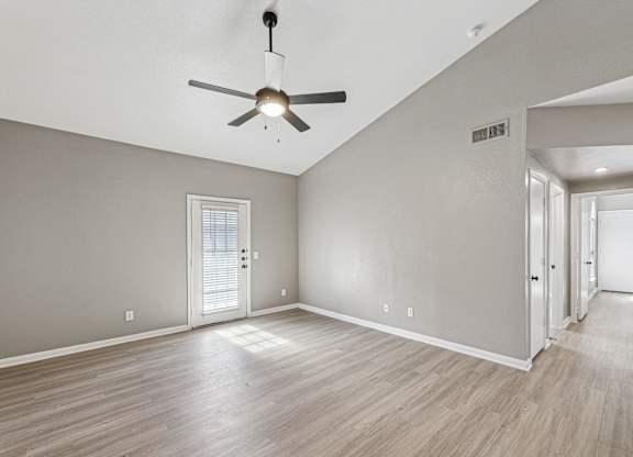 A room with a ceiling fan and wooden flooring at Clear Creek Meadows Apartments, Copperas Cove, Texas