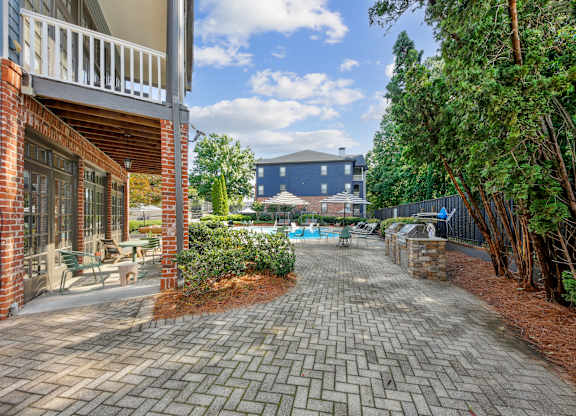 A brick building with a pool in the backyard.