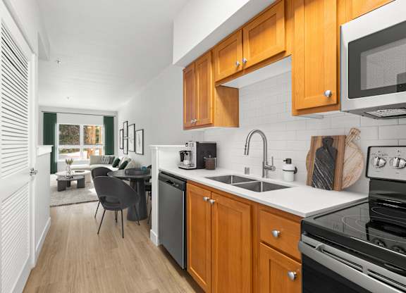 A kitchen with wooden cabinets and a black stove top oven.
