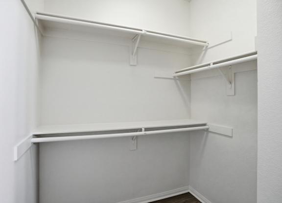 Empty white shelves in a room.