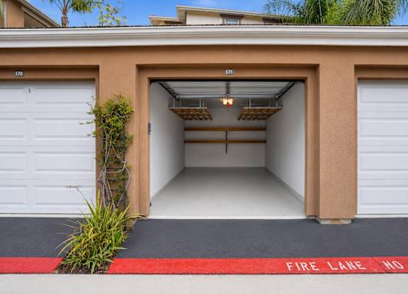 A garage with a red fire lane no stop sign.
