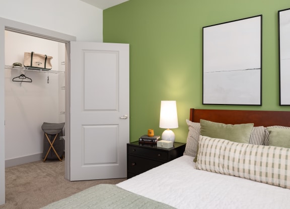 a bedroom with green walls and a white bed