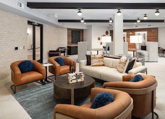 a living room with couches and chairs and a table