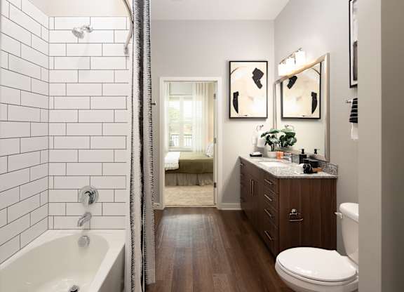 a bathroom with a shower and a sink and a toilet