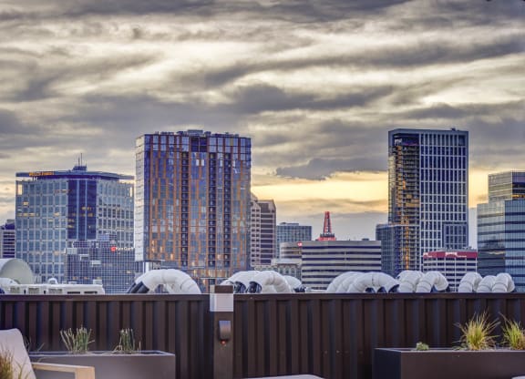 a view of the city skyline from a rooftop bar