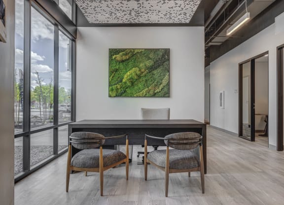 a working table with a table and three chairs