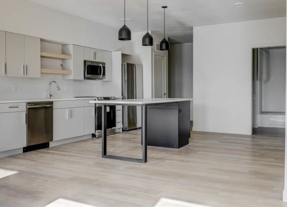 an empty kitchen with an island in the middle of it