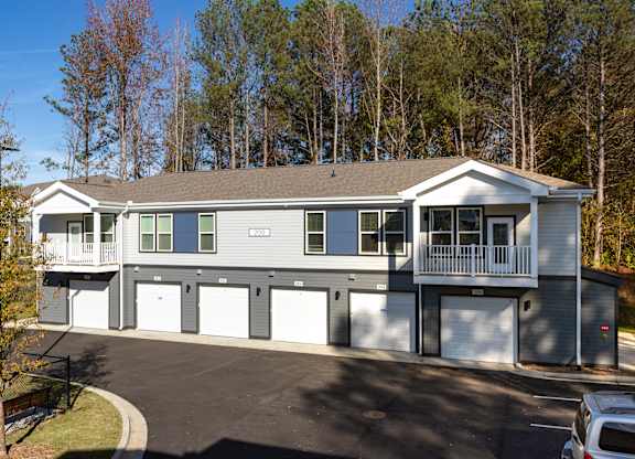A two-story house with a garage and a driveway.