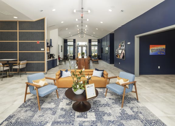 a lobby with a couch and chairs and a table