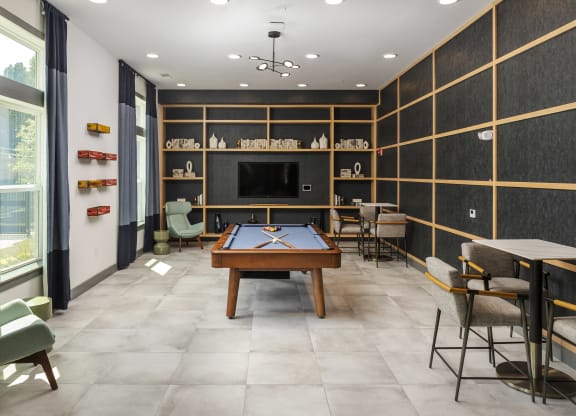 a game room with a pool table and a television
