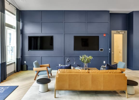 a living room with blue walls and a yellow couch