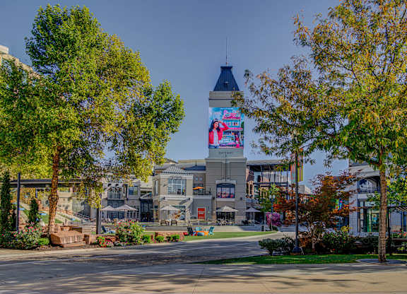 A large building with a tower and a billboard on it.