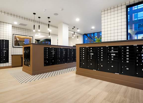 A room with black cabinets and a wooden floor.