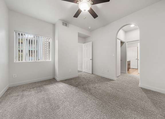 Inviting bedroom with ample natural light, neutral walls, and a thoughtfully designed layout.