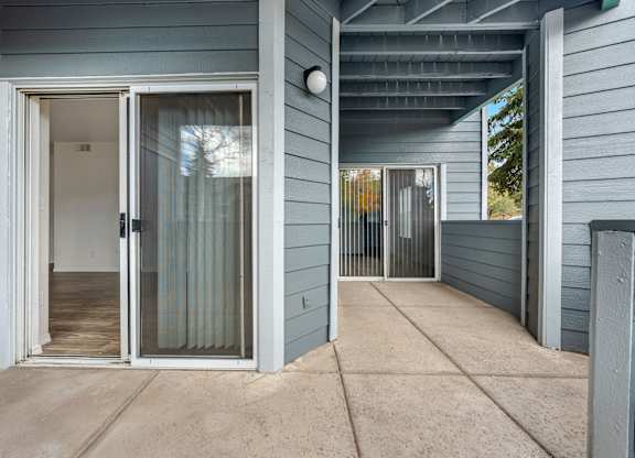 A house with a grey exterior and a glass door.