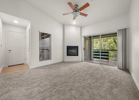 A spacious living room with a fireplace and sliding glass doors.