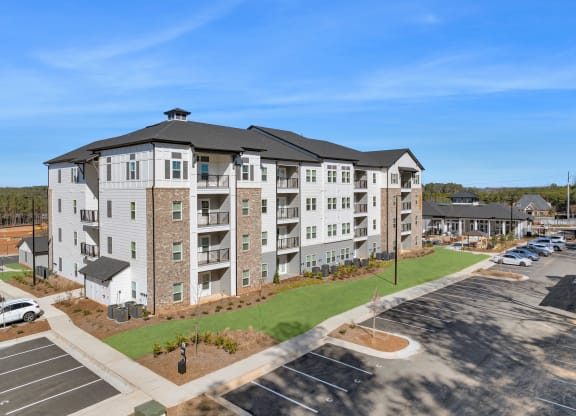 an aerial view of an apartment building with a parking lot
