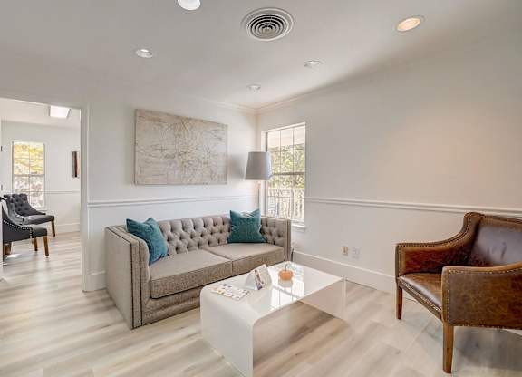 A living room with a grey couch and a coffee table.