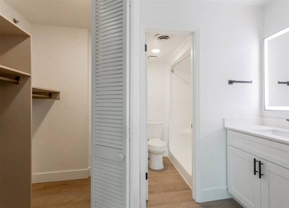 A white bathroom with a toilet and sink.