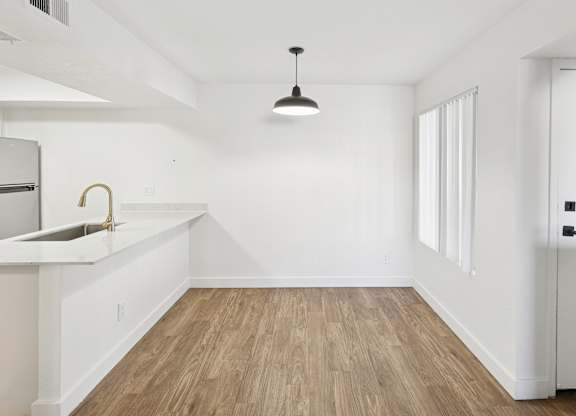 A kitchen with a sink and a counter.