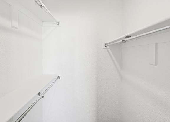 A white wall with a metal rail on top.