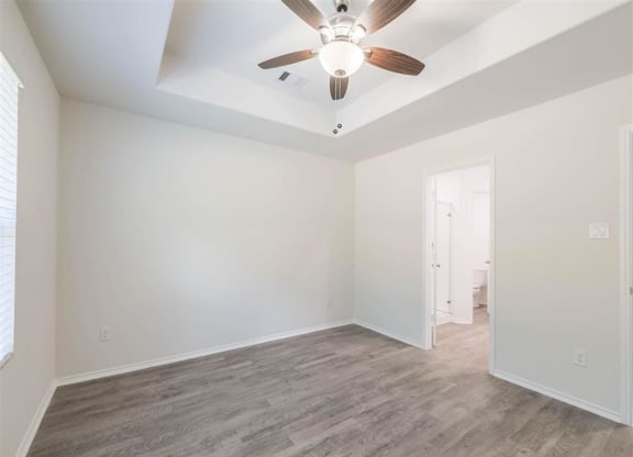 an empty room with a ceiling fan at The Village at Caney Mills, Conroe, Texas